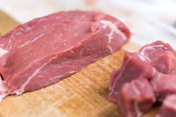 Beef steak cut into cubes. Red meat on the cutting board