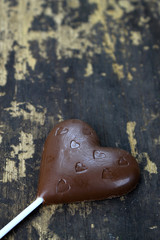 Chocolate heart on wooden background