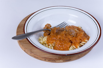 Served beef stew with macaroni in the metal plate