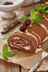 Swiss cake roll with cream and cherries