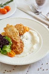 a portion of fried fish with cauliflower puree