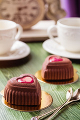 French heart shaped mousse cake covered with chocolate velour