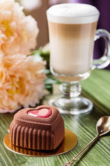 French heart shaped mousse cake covered with chocolate velour