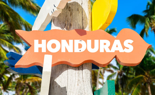 Honduras welcome sign with palm trees