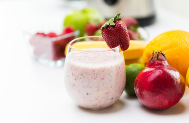 close up of glass with milk shake and fruits