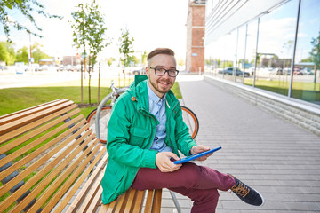 happy young hipster man with tablet pc and bike