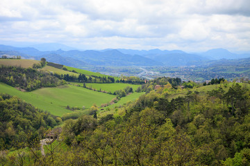 Obraz premium Aerial view to the green hills, forest and town nearby Bologna town 
