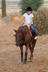 little girl is riding a horse