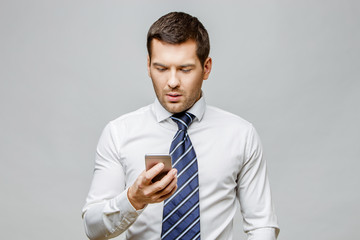 Handsome stylish businessman on grey background