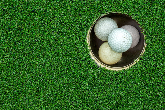 Top view of golf balls stacked up in green field