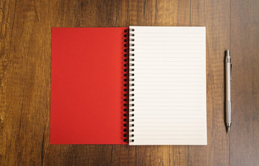 Note book with pencil on a wooden desk