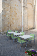 Fototapeta na wymiar Typical Parisian cafe terrace at famous near a stone of wall