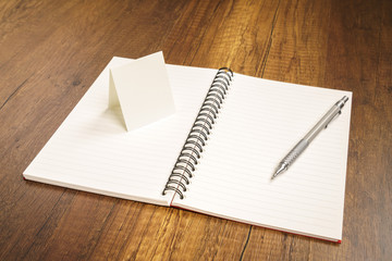 Note book with pencil on a wooden desk