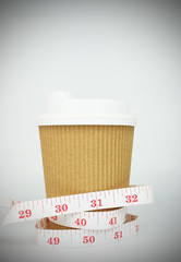 Paper cup coffee with tape measure