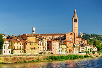 Fototapeta na wymiar Houses on waterfront of Adige River and Santa Anastasia, Verona