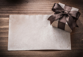 Present box paper on vintage wooden board holiday concept