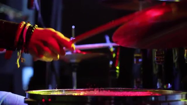 Concert of rock band. Drummer playing on stage