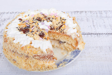 Biscuit cake with crumbs, whipped cream