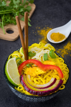 Thai noodles and curry on a rustic wood

