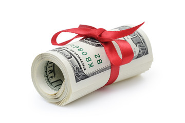 rolled dollar banknotes tied with red ribbon, isolated on white