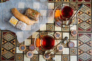 Turkish sweets and tea on the backgammon Board