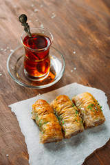 Turkish sweets baklava and tea on a dark background
