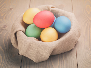 Fototapeta na wymiar hand painted easter eggs in bowl, vintage toned