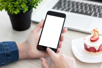 Women hands holding the phone with isolated screen on table