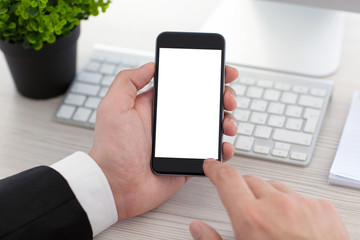 Businessman hands holding phone with isolated screen in the offi