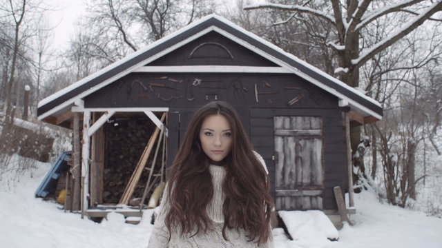 Natural Young Brunette Woman Wearing Knitted Sweater Standing By The Tool Shed. Winter Fashion Concept.