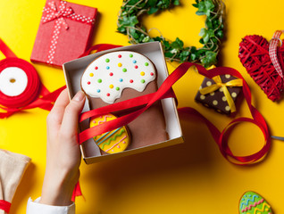 Female hands are holding Easter cookie