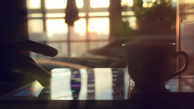 Young woman with coffee in cafe using digital tablet. 1920x1080