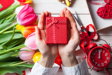 Female hands are holding a gift