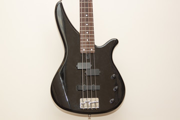 Plakat black bass electric guitar hanging on the wall