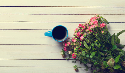  bouquet of roses and cup of coffee