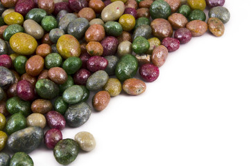 Multicolored glazed raisins on a white background