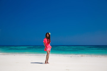 Fototapeta na wymiar Beautiful woman walking on exotic beach, brunette girl model in