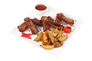 Single spareribs with potato sliced on white square serving dish