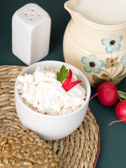 cottage cheese with radish, milk jug and wholemeal bun