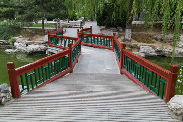 Walkway across the river in Old traditional park in Beijing,  China