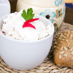 cottage cheese with radish, milk jug and wholemeal bun