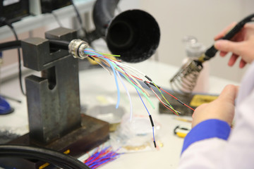 factory worker assembles the cable connections