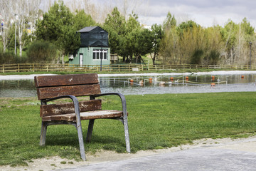 empty rustic wooden armchair outdoor in the park  to rest
