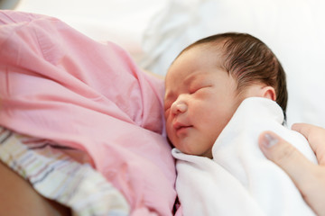 Asian mother with newborn baby in the hospital