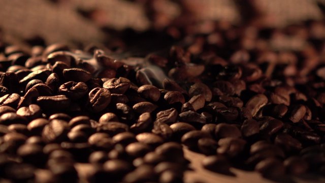 Coffee beans with star anise on barrel, cam moves to the right, close up
