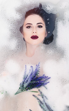 woman with flowers in the foam bath