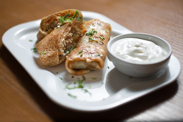 pancakes with chicken on wooden table
