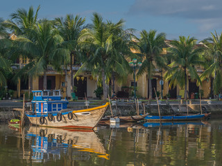 Fototapeta na wymiar Morning sun on traditional wooden boats along the Thu Bon River in Hoi An, Vietnam.