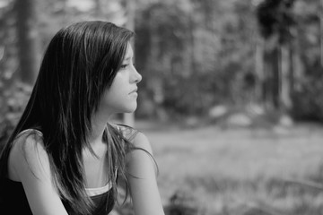 Thinking young woman alone in a park