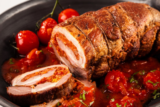 Close up of pork roast and tomatoes